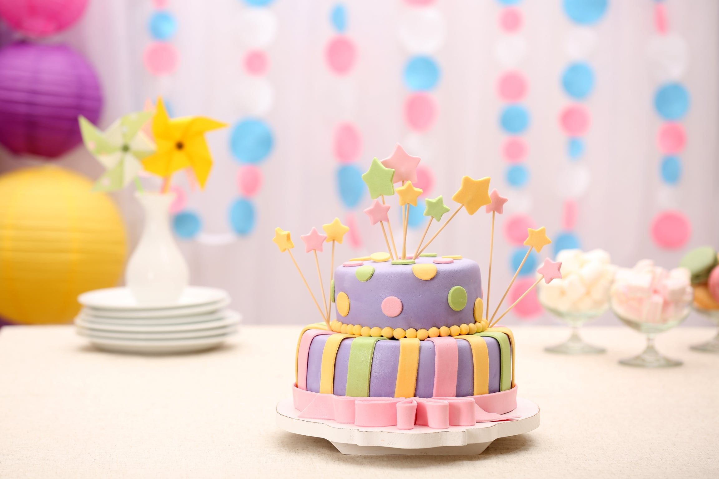 Delicious Birthday Cake on Table on Bright Background